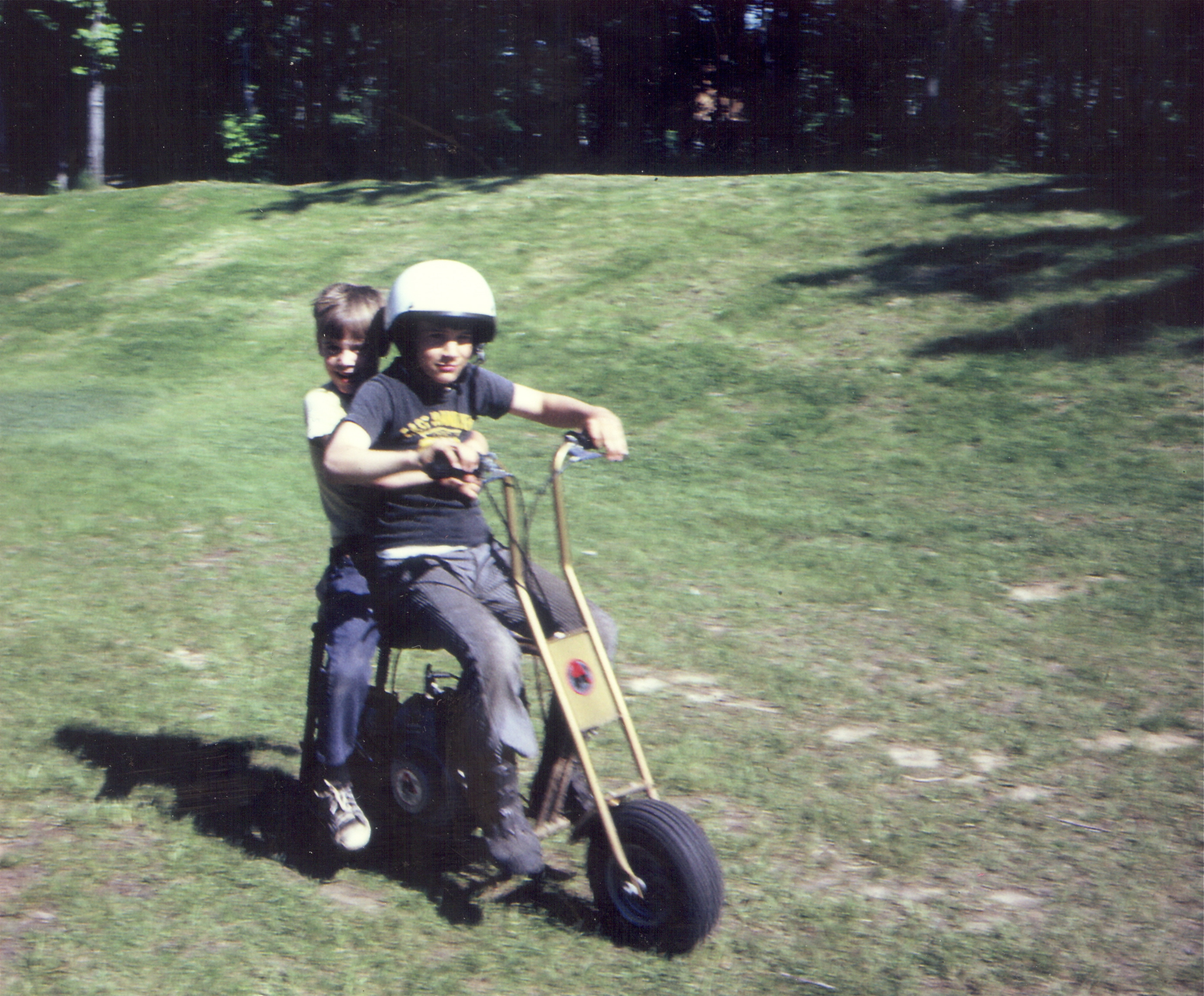 My brother John giving me my first ride on a minibike.